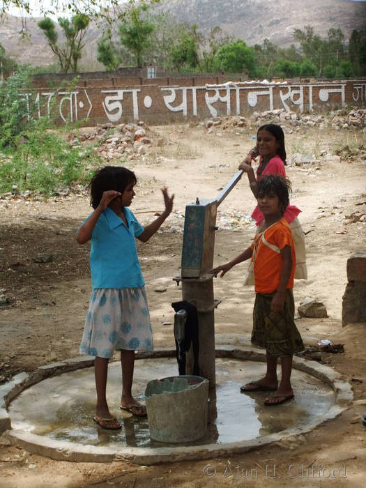 Children at a water pump near Ranthambhore