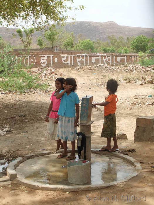 Children at a water pump near Ranthambhore